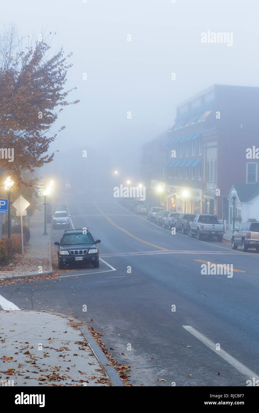 Main Street (Route 1) in downtown Camden, Maine USA on a foggy autumn morning. The town of Camden is located on the coast of Maine. Stock Photo