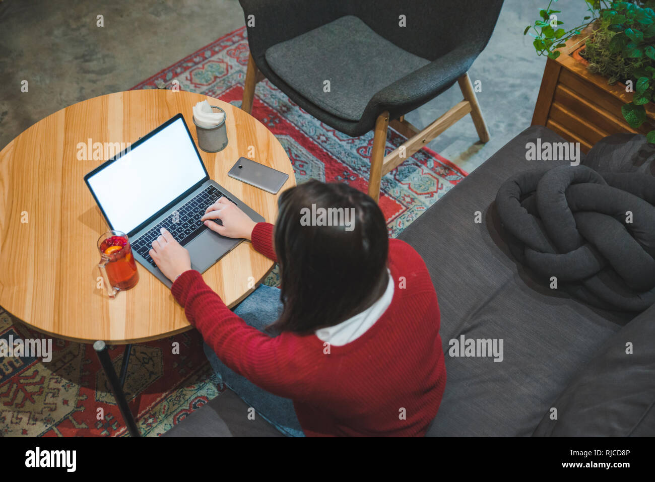 woman sitting in cafe using laptop drinking tea. white screen. copy ...