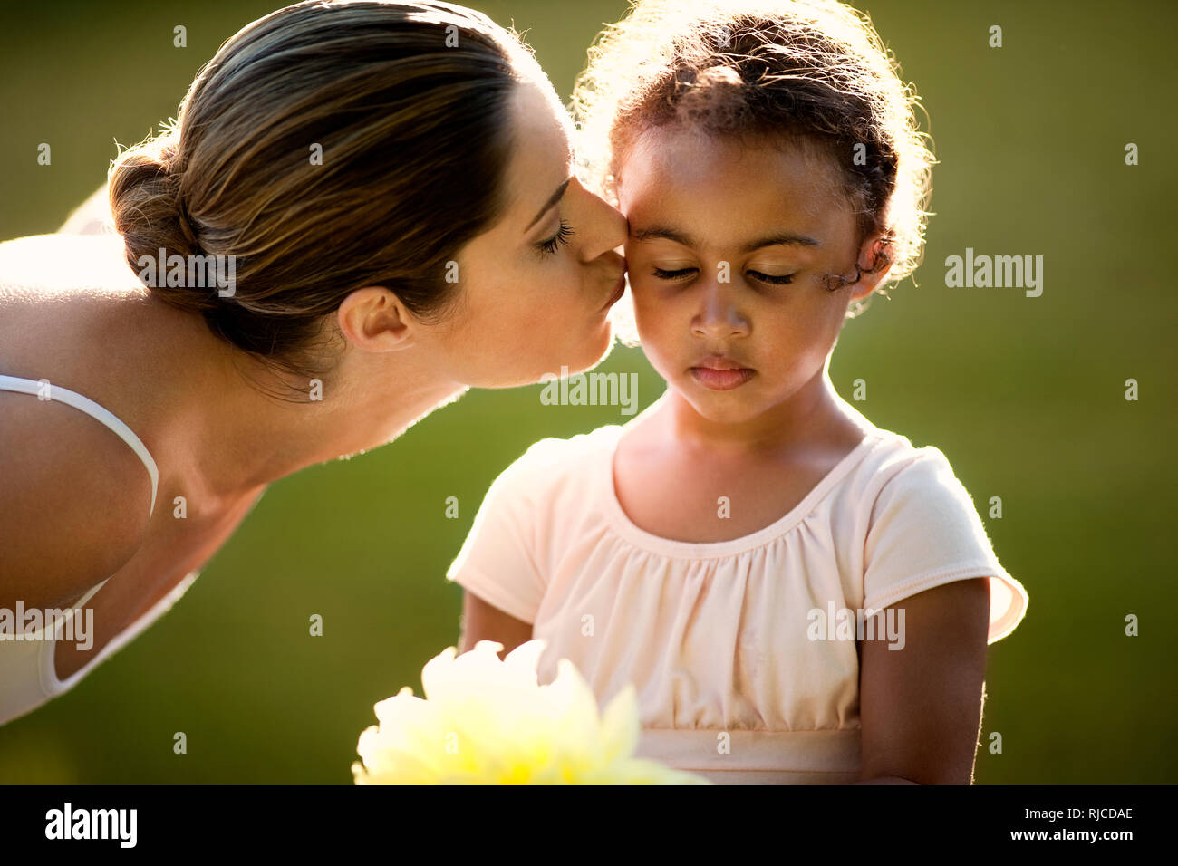 Young girl and her mother wearing tutus in a park. Stock Photo