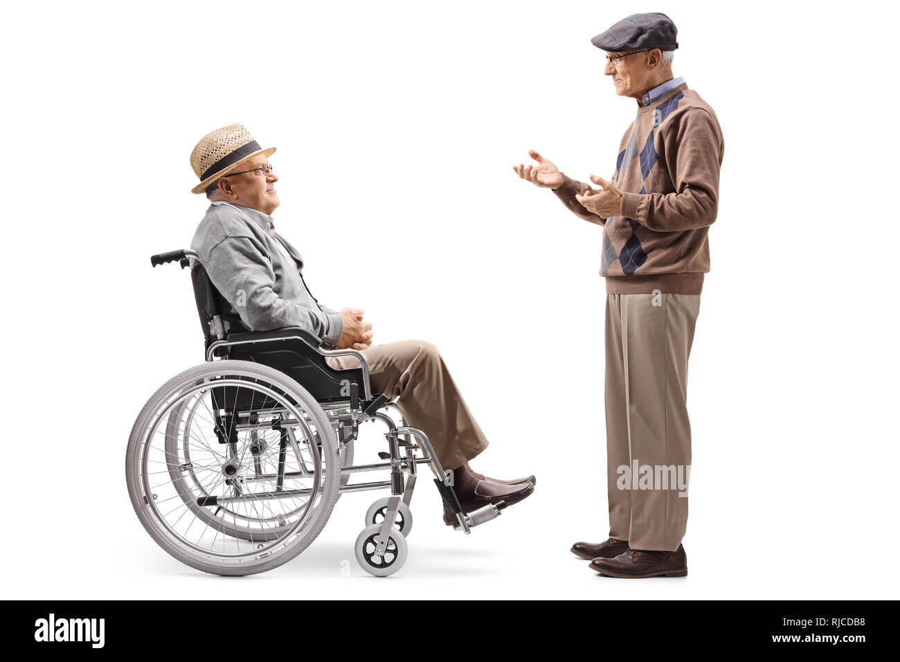 Full length profile shot of an elderly man talking to a disabled man in a wheelchair isolated on white background Stock Photo