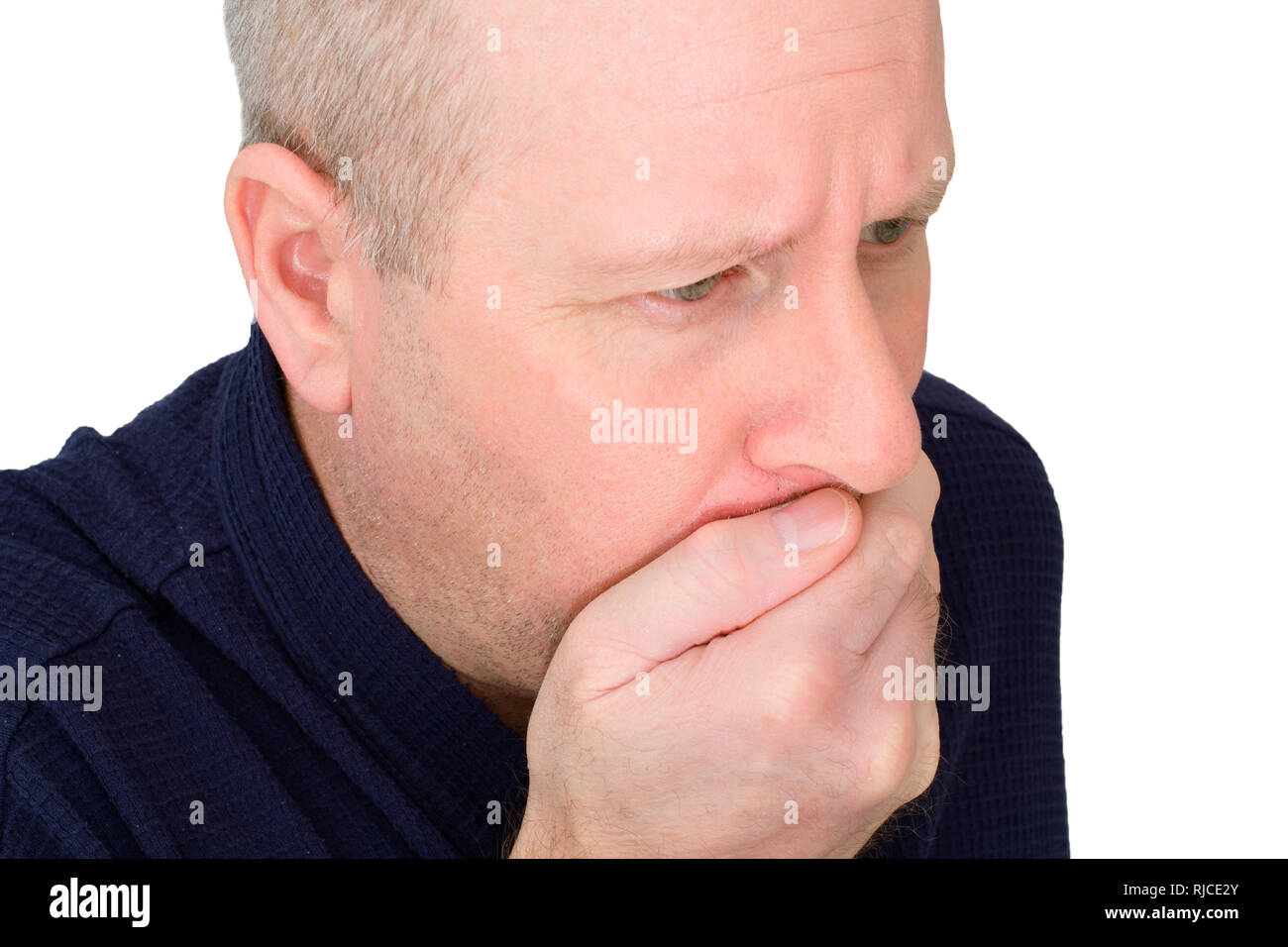 Caucasian male suffering nausea with hand over mouth. Stock Photo