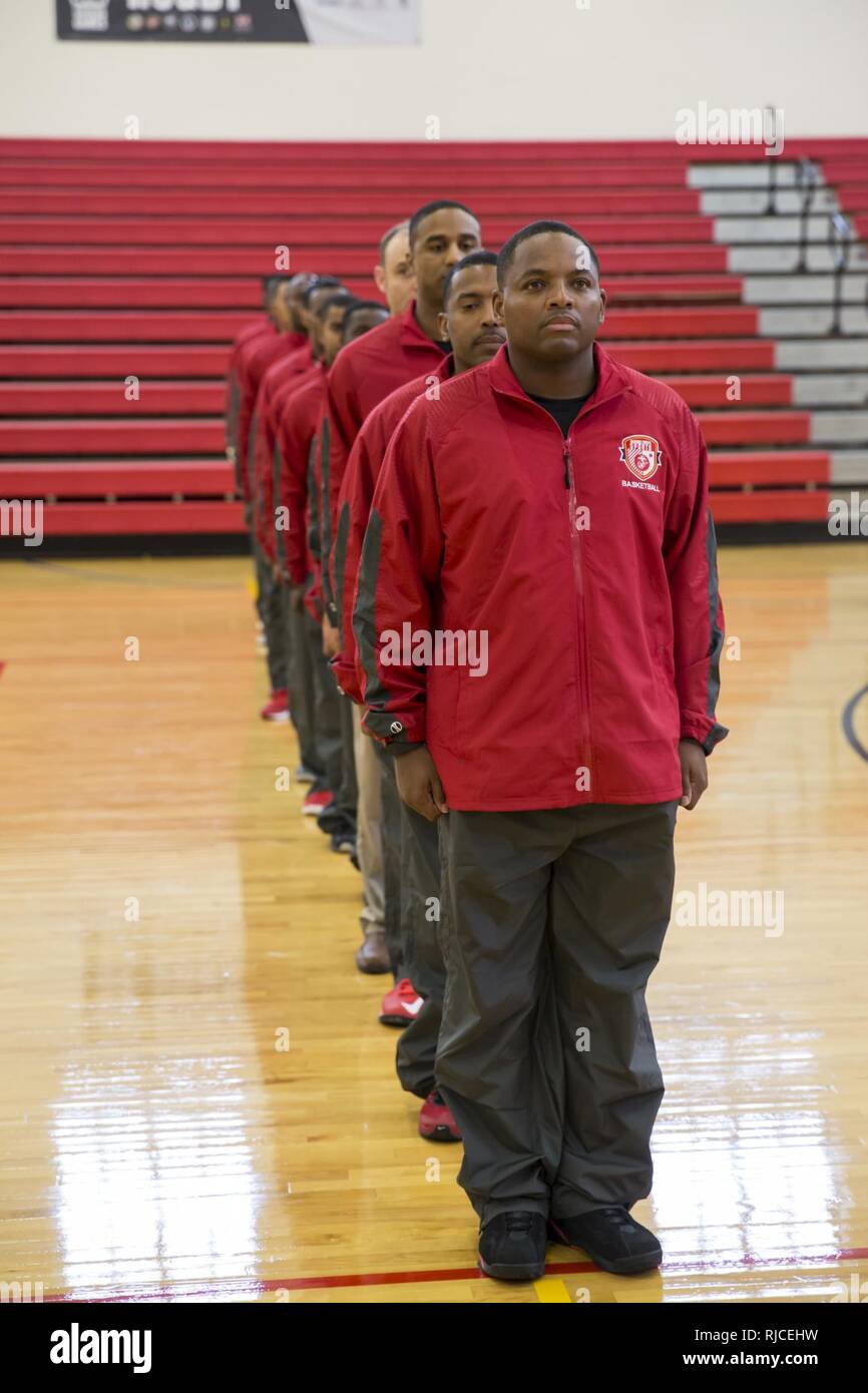 U.S. Military members of the All Marine basketball team stand in