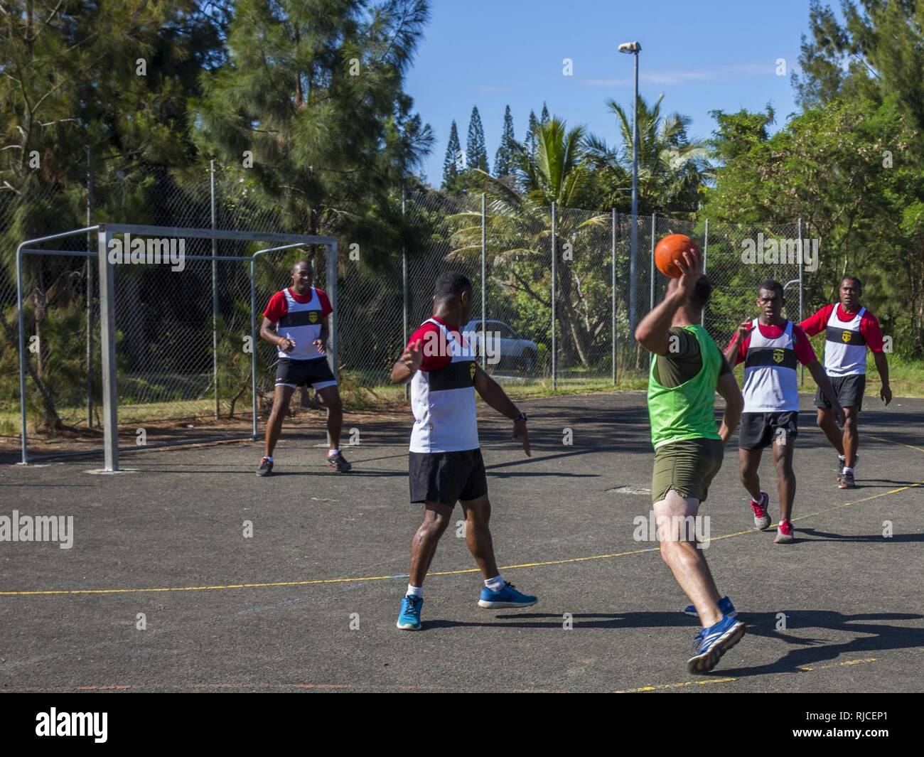 U.S. Marines with Combat Engineer Platoon, Task Force Koa Moana 16-4, integrate with the Republic of Fiji Military Forces and play hand ball during Croix Du Sud in Plum, New Caledonia, Nov. 6, 2016. Croix Du Sud is a multi-national, humanitarian assistance disaster relief and non-combatant evacuation operation exercise conducted every two years to prepare nations in the event of a cyclone in the South Pacific. The Koa Moana exercise seeks to enhance senior military leader engagements between allied and partner nations in the Pacific with a collective interest in military-to-military relations. Stock Photo