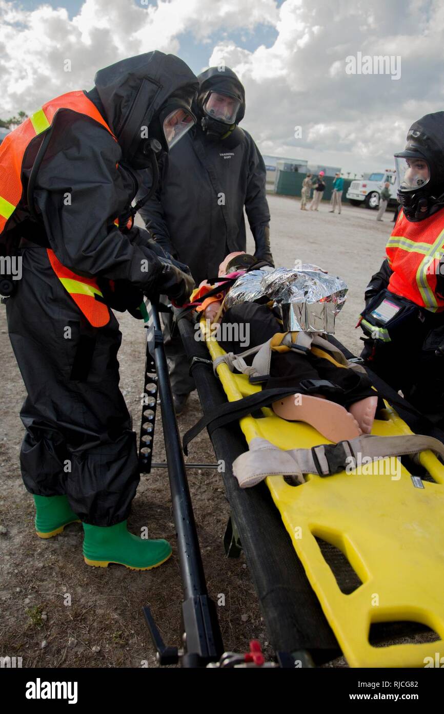U.S. Army Soldiers of the 414th Chemical Company, asses a causualty for a simulated mass chemical attack during a Joint Training Exercise hosted by the Miami-Dade Fire Department and Homestead-Miami Speedway in Miami, Fla. Jan. 11, 2018. This JTE focused on building response capabilities and seamless the transition between the local first responders and the follow-on support provided by the National Guard and Active duty soldiers. (U. S. Army Stock Photo