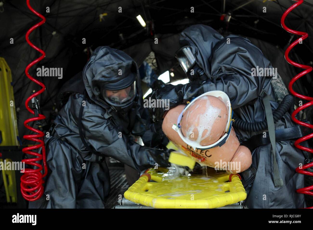 Soldiers assigned to the 414th Chemical Company from Orangeburg, South Carolina wash a simulated casualty during a Joint Training Exercise hosted by the Homestead-Miami Speedway and Miami-Dade Fire Department in Miami, Florida. Jan. 11, 2018. This JTE focused on building response capabilities and the seamless transition between the local first responders and the follow-on support provided by the National Guard and Active duty soldiers. (U. S. Army Stock Photo