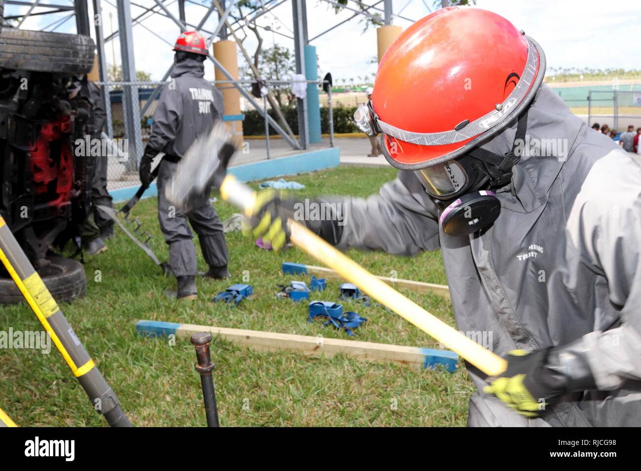 A Soldier of the 414th Chemical Company fro Orangeburg, South Carolina hammers in a support rod during a Joint Training Exercise hosted by the Homestead-Miami Speedway and Miami-Dade Fire Department in Miami, Florida. Jan. 11, 2018. This JTE focused on building response capabilities and the seamless transition between the local first responders and the follow-on support provided by the National Guard and Active duty soldiers. (U. S. Army Stock Photo