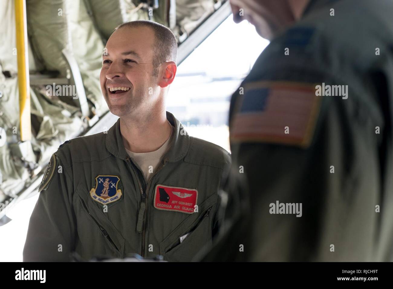 POPE ARMY AIRFIELD, N.C. — Capt. Jeff Gebhardt, an aircrew member in the 165th Airlift Wing of the Georgia Air National Guard, gives a pre-flight briefing to aircrew and Soldiers aboard a C-130H Hercules on Green Ramp during joint airdrop training here Jan. 10, 2018. The aircraft and crew are from Savannah, Ga. Airmen in the 43d Air Mobility Squadron and 43d Air Base Squadron here supported both the visiting aircrew and Army units throughout the training. The 43d Air Mobility Operations Group, which is part of Air Mobility Command, powers airlift training and real-world operations for Army and Stock Photo