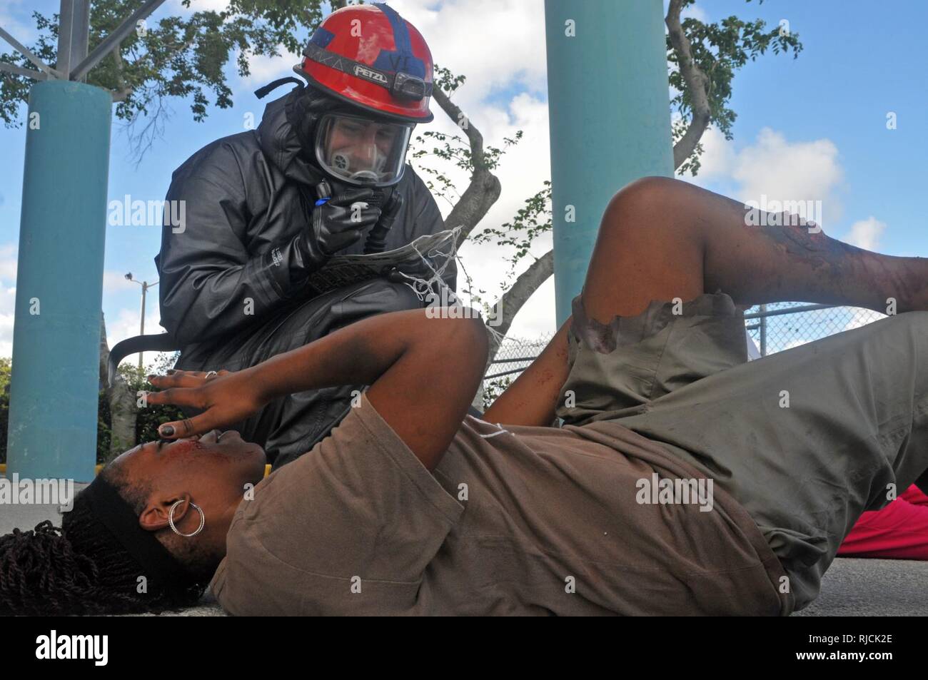 U.S. Army Reserve Spc. Jordan Nunes, Attachment 8, 328th Combat Support Hospital, triages a  'victim'  of a simulated mass chemical attack during the Joint Training Exercise hosted by the Homestead-Miami Speedway and Miami-Dade Fire Rescue Department in Miami, Florida. Jan. 11, 2018. This JTE focused on building response capabilities and the seamless transition between the local first responders and the follow-on support provided by the National Guard and Active Army Soldiers. (U. S. Army Reserve Stock Photo