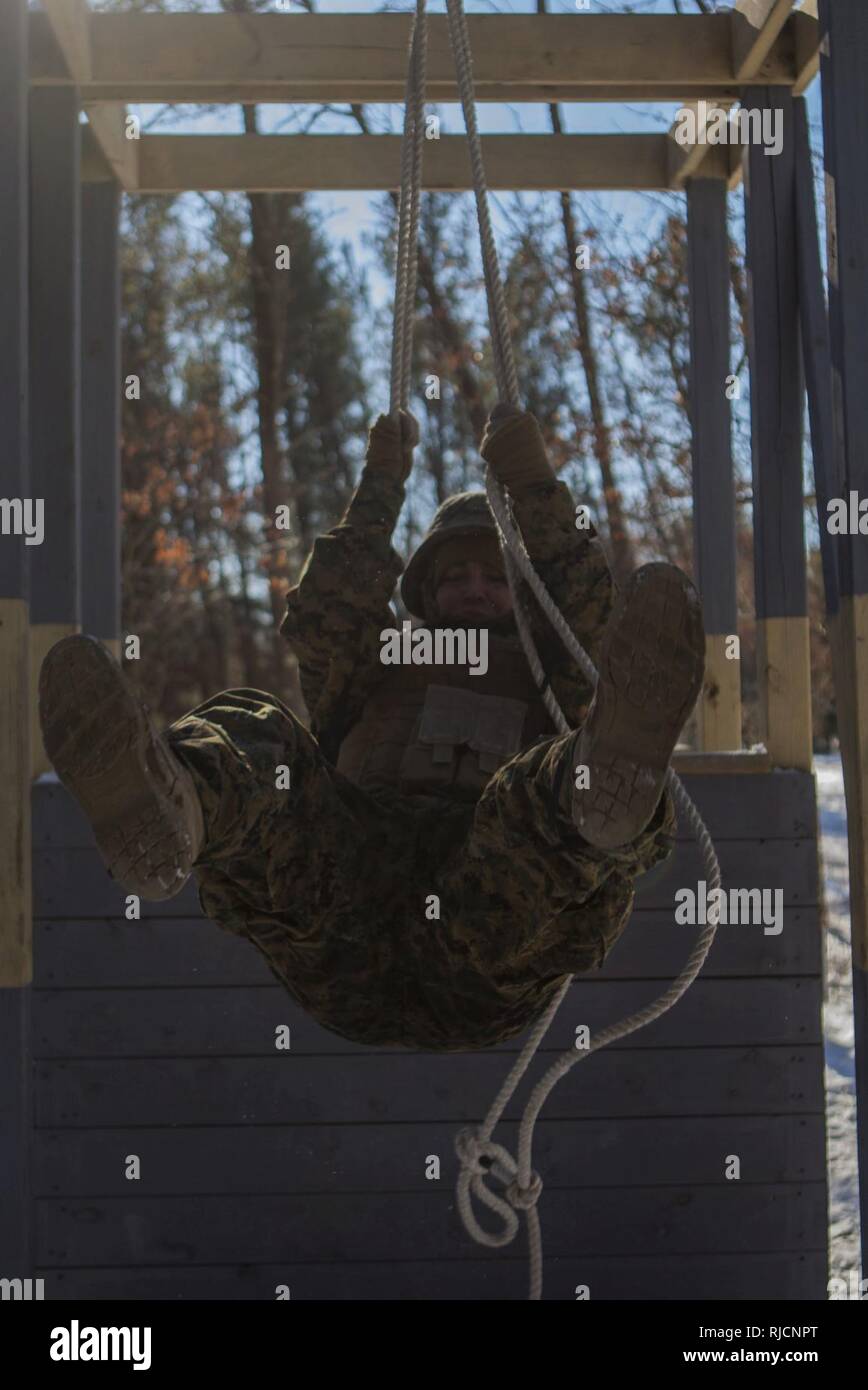 U.S. Marine Lance Cpl. Kameron V. Kraintz, a Data Systems Administrator assigned to Marine Wing Communications Squadron 48, participates in a team building exercise on the Field Leadership Reaction Course during Ullr Shield on Fort McCoy, Wis., Jan. 18, 2018. Ullr Shield is a training exercise designed to improve 2nd Marine Aircraft Wing's capabilities in extreme cold weather environments. Stock Photo