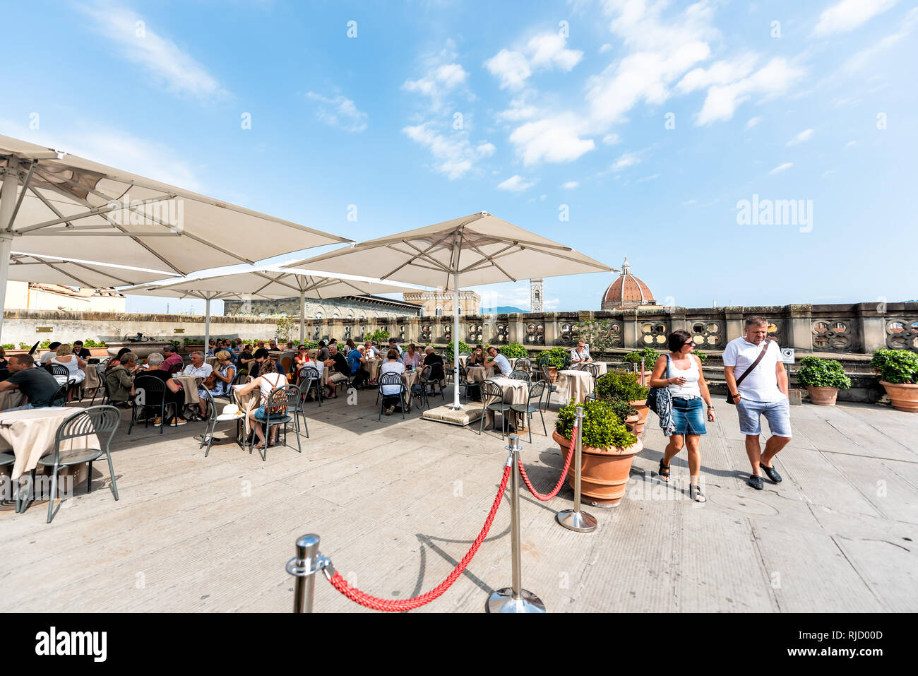 Firenze, Italy - August 30, 2018: Many people by cafe on terrace of famous Florence Uffizi art museum gallery with view of old building church duomo Stock Photo
