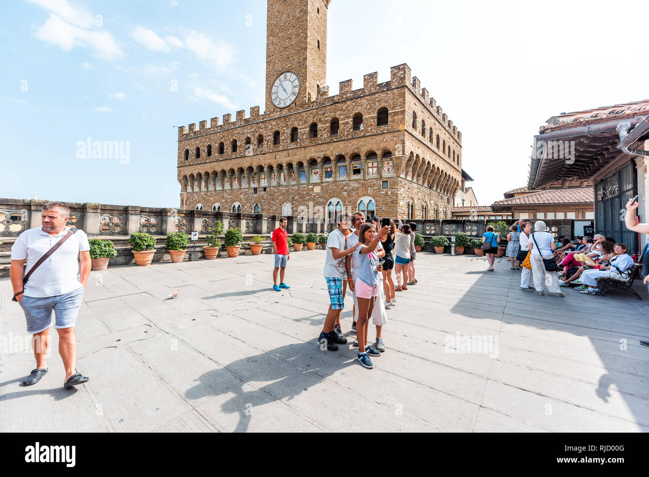 Firenze, Italy - August 30, 2018: Many people by cafe on rooftop terrace of famous Florence Uffizi art museum gallery with view of old building Palazz Stock Photo