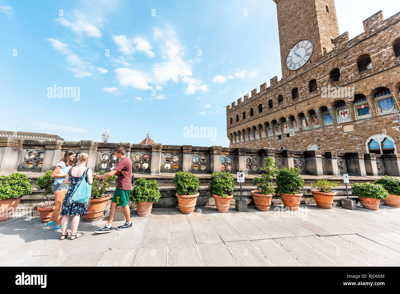 Firenze, Italy - August 30, 2018: Many people on rooftop terrace of famous Florence Uffizi art museum gallery with view of old building Palazzo Vecchi Stock Photo