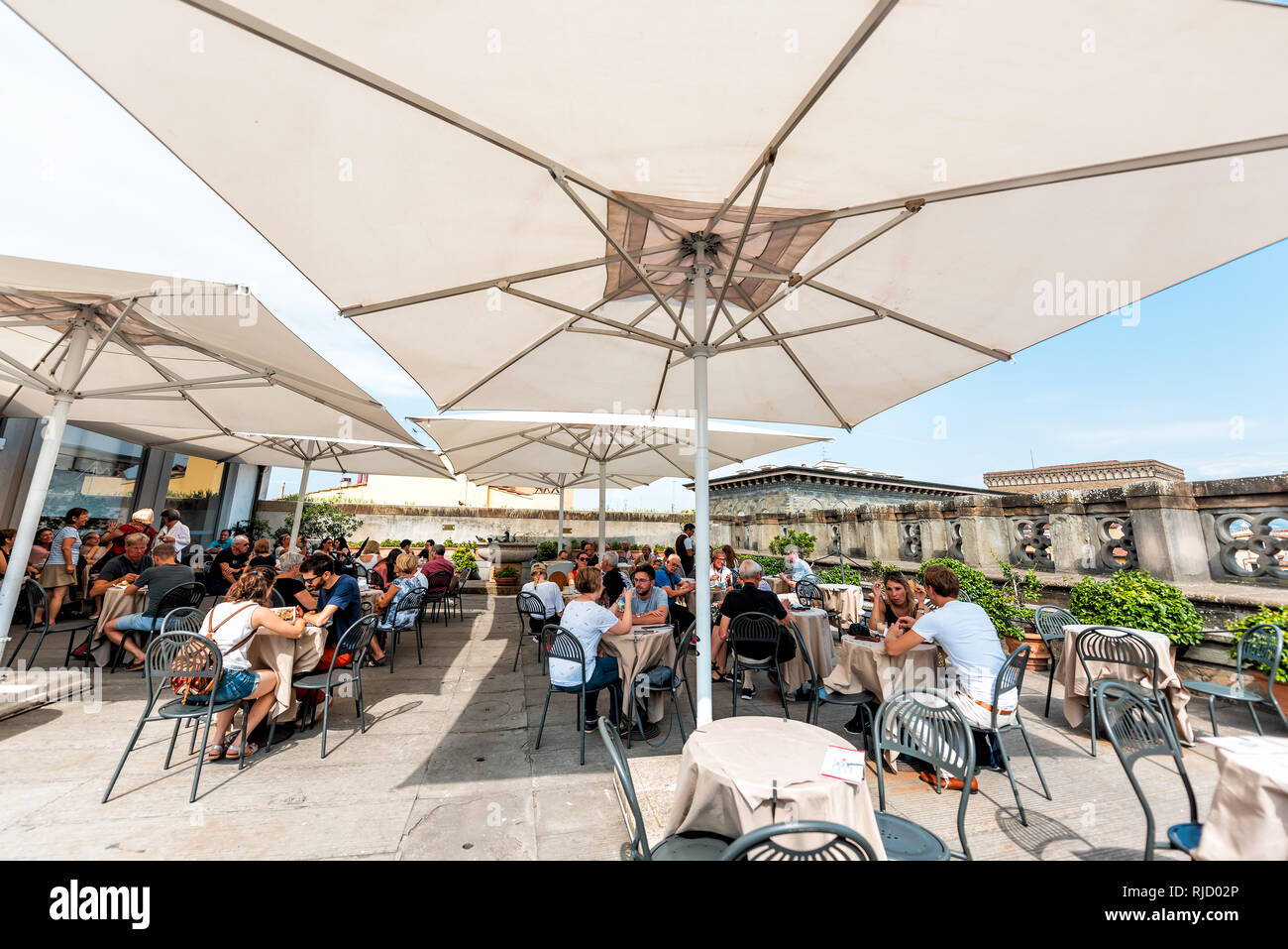 Firenze, Italy - August 30, 2018: Many people by cafe on terrace of famous Florence Uffizi art museum gallery with restaurant and shade cover Stock Photo