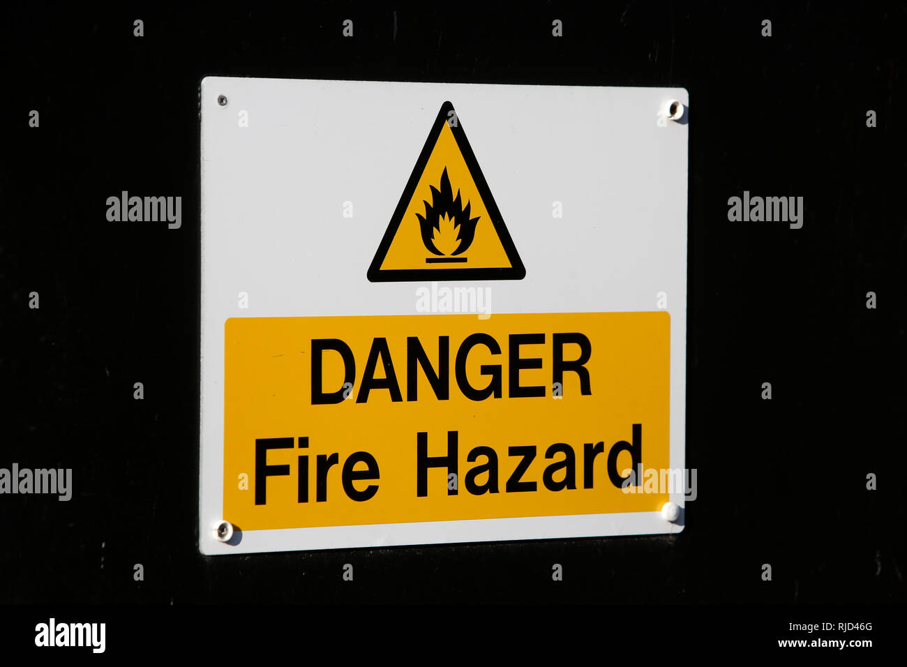 General views of a Danger Fire Hazard sign on a door in West Sussex, UK. Stock Photo