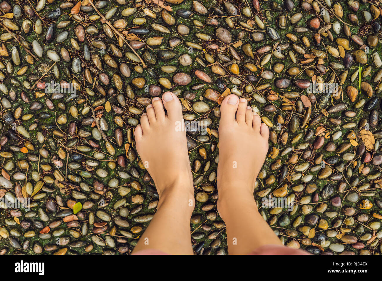 Woman Walking On A Textured Cobble Pavement Reflexology Pebble Stones