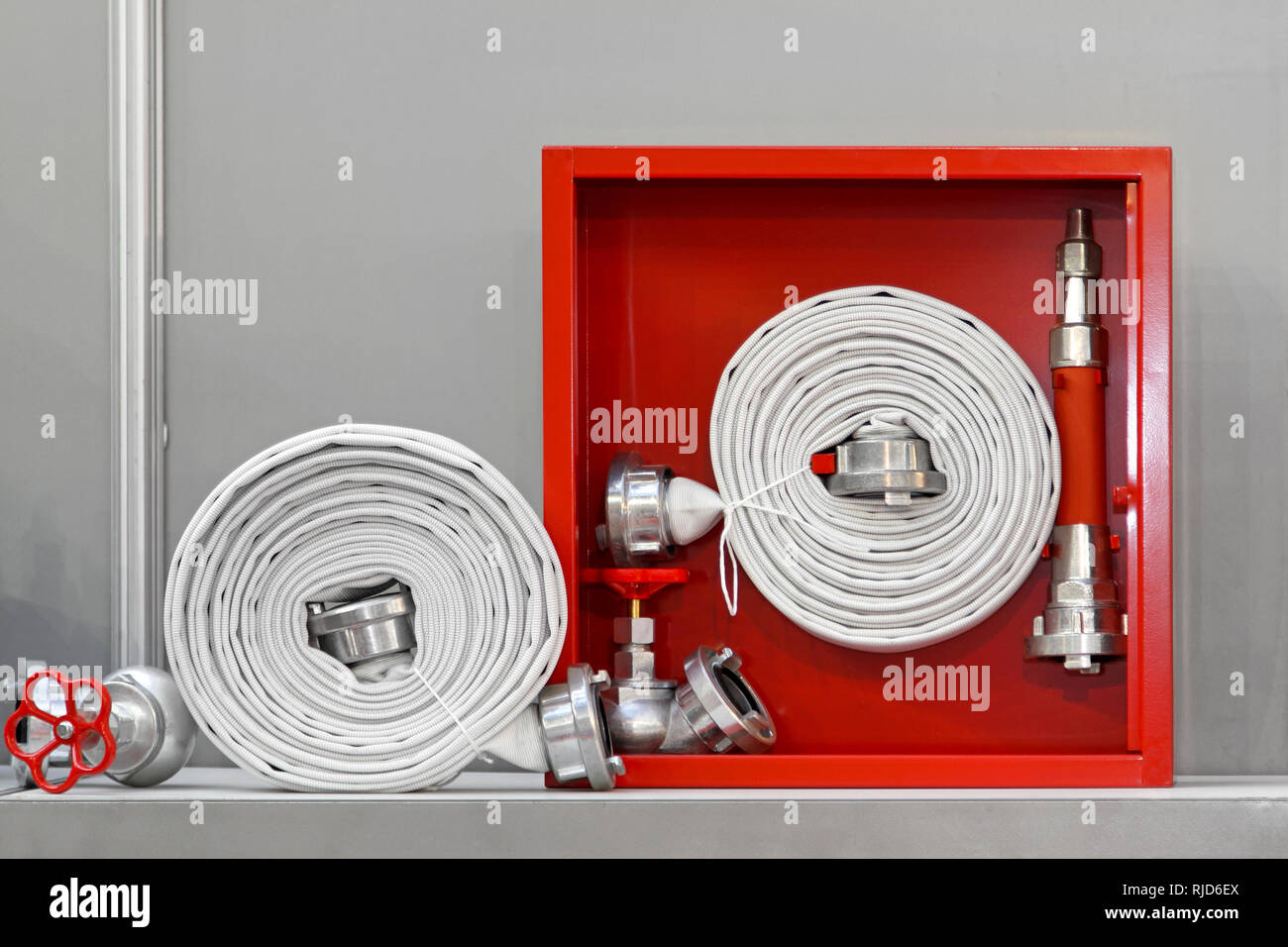 Hydrant with water hoses and fire extinguish equipment Stock Photo - Alamy