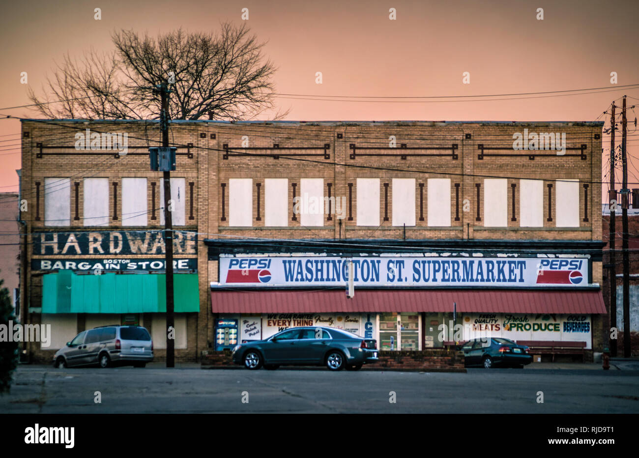 The sun sets behind Washington St. Supermarket, Feb. 14, 2015, in Selma, Alabama. Stock Photo