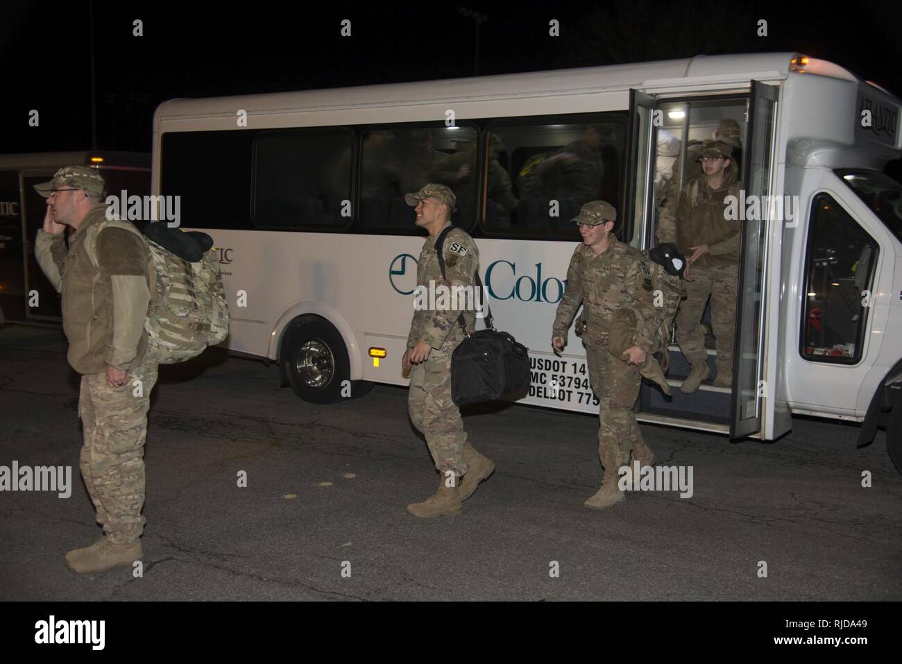 Defenders assigned to the 436th Security Forces Squadron return home from deployment to the Middle East Jan. 21, 2018, at Dover Air Force Base, Del. The 12 Defenders departed the bus after a long day of flights returning them to Dover AFB. Stock Photo