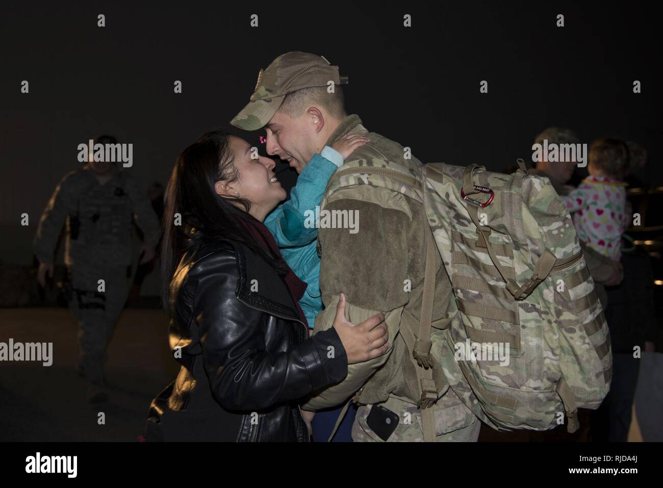 Staff Sgt. Justin Stevenson, 436th Security Forces Squadron defender, kisses his wife, Jamielee, while hugging his daughter, Julia, upon his return home from deployment to the Middle East Jan. 21, 2018, at Dover Air Force Base, Del. Stevenson’s team has been deployed since July 2017. Stock Photo