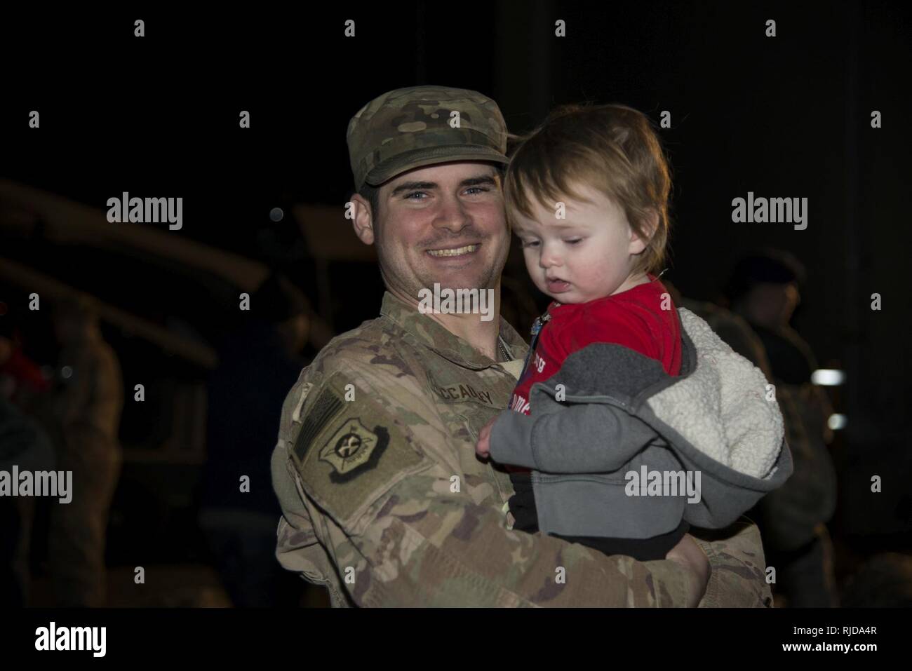 Staff Sgt. Issac McCauley, 436th Security Forces Squadron defender, holds Jaxon, his son, after returning home from deployment Jan. 21, 2018, at Dover Air Force Base, Del. McCauley is one of twelve defenders sent to the Middle East for a six-month deployment. Stock Photo