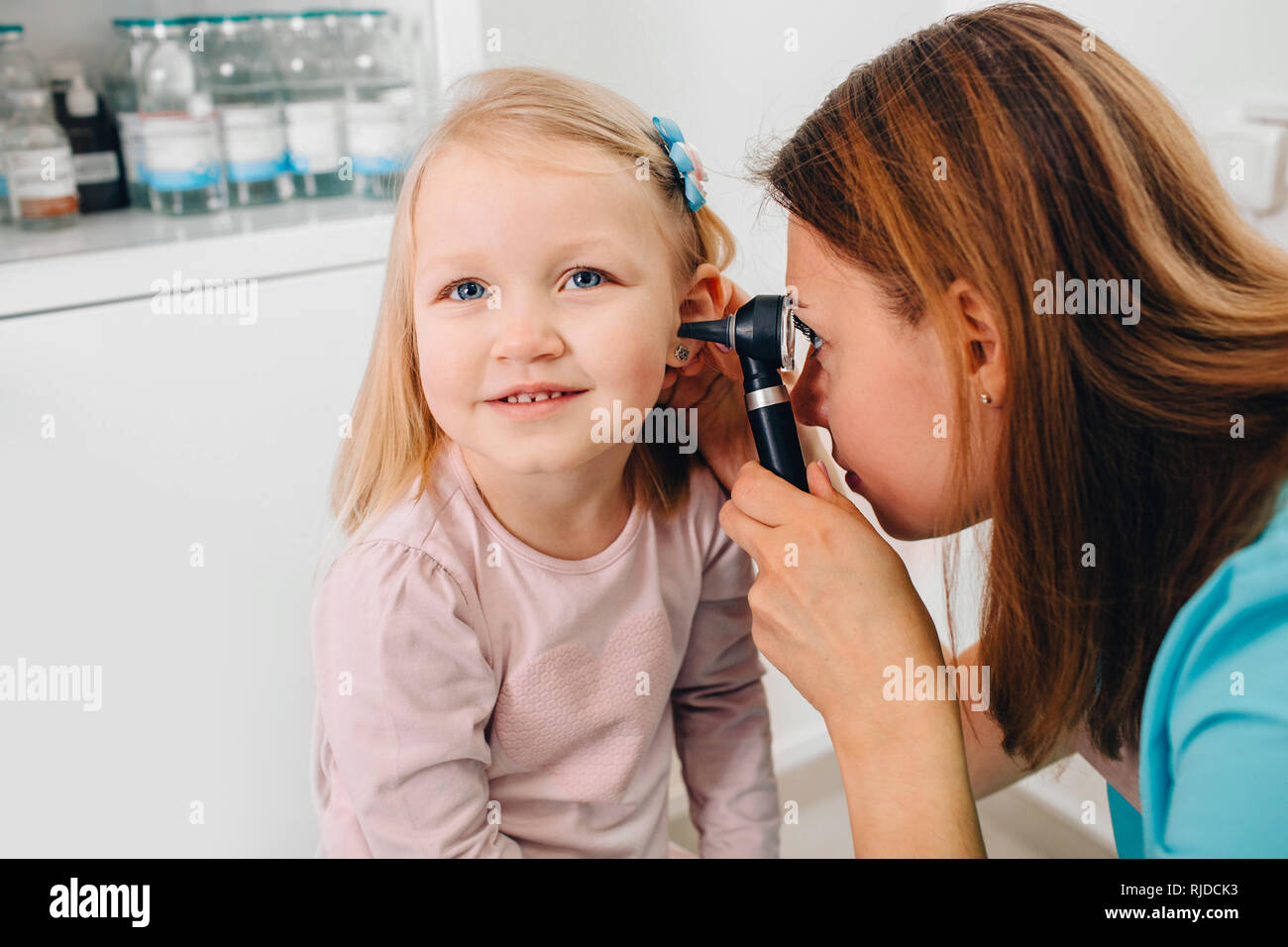 Smiling little patient having ear exam with otoscope Stock Photo Alamy