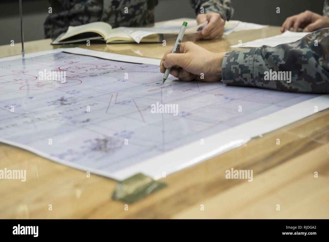 Japan Air Self Defense Force members identify important information by ...