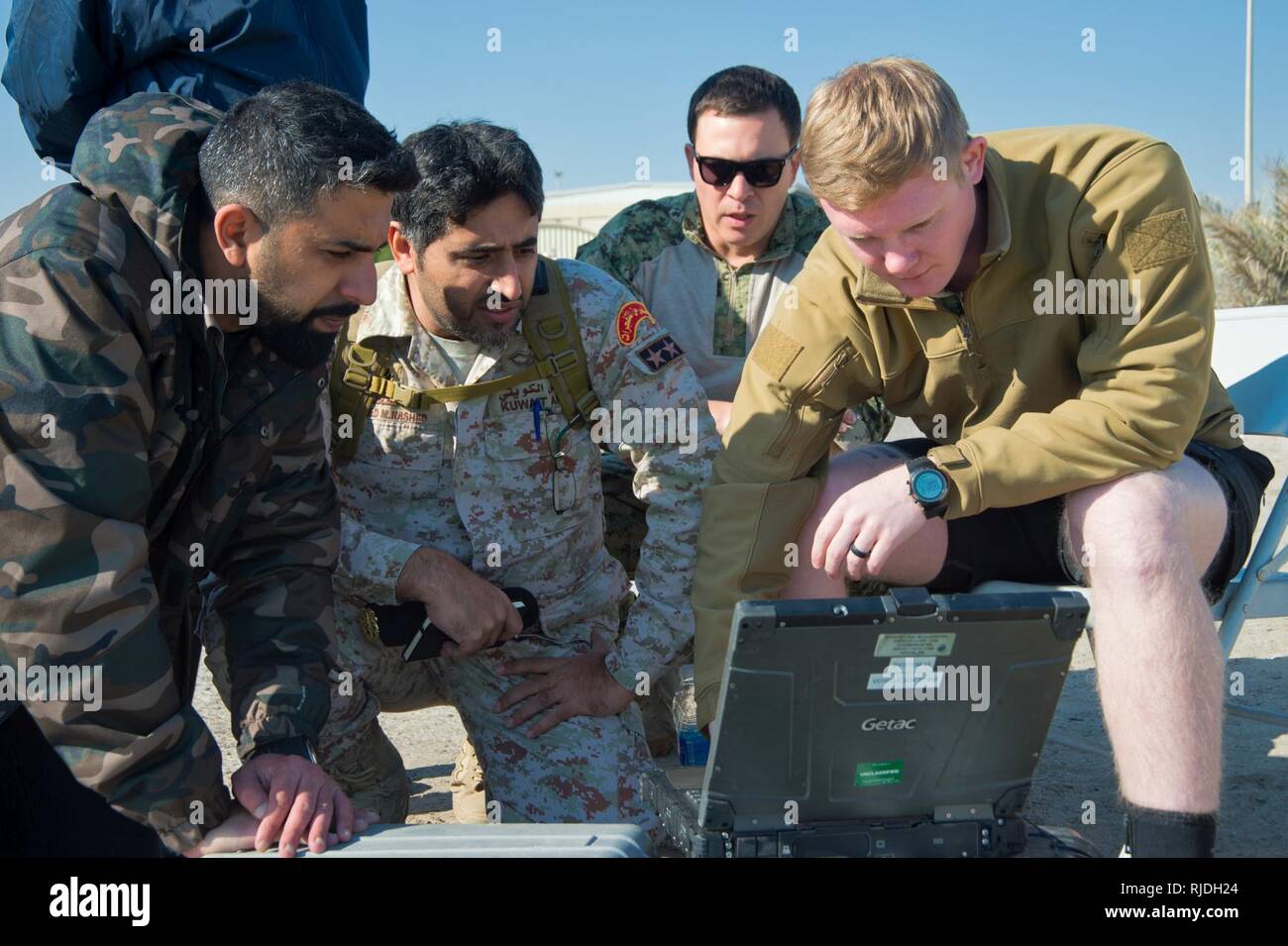 Mohammed Al-Ahmad Naval Base, KUWAIT (Jan. 9, 2018) Mineman 2nd Class Dylan Duncan, assigned to Commander, Task Group 56.1, demonstrates pre-mission checks on an unmanned underwater vehicle to Kuwait Naval Force explosive ordnance disposal technicians during a training evolution as part of exercise Eager Response 18. Eager Response 18 is a bilateral explosive ordnance disposal military exercise between the State of Kuwait and the United States. The exercise fortifies military-to-military relationships between the Kuwait Naval Force and U.S. Navy, advances the operational capabilities of Kuwait Stock Photo