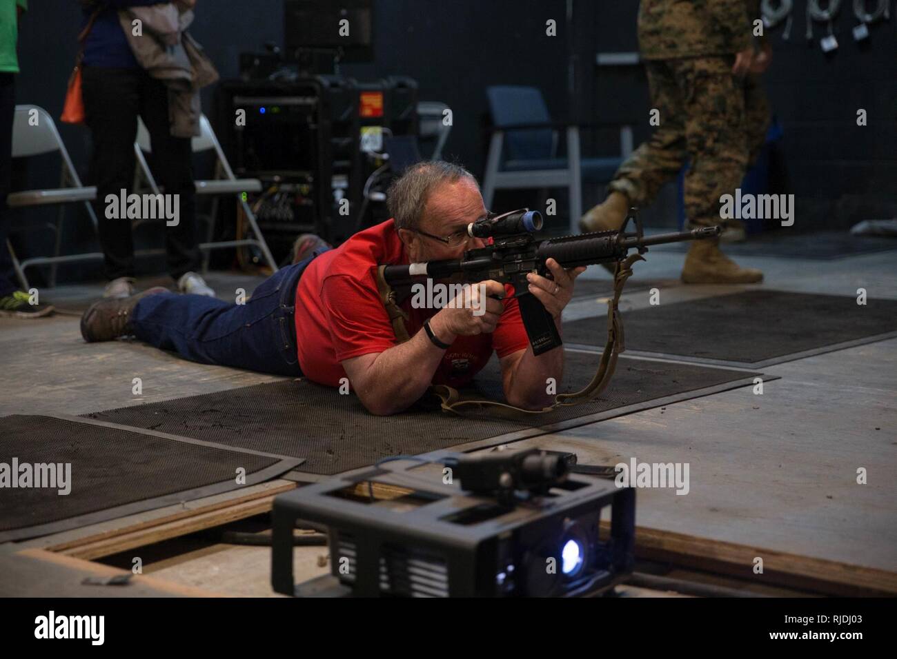 Dave Glynn from Cedar Rapids, Iowa, shoots a mock M16A4 rifle at the
