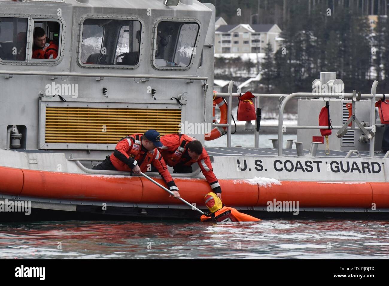 Members of Coast Guard Station Juneau pull a dummy out of the water
