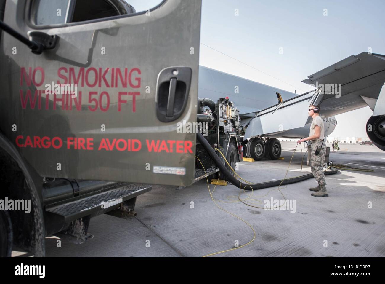 U.S. Air Force Airman Austin Collings, fuels distribution specialist assigned to the 379th Expeditionary Logistics Readiness Squadron, watches fuel gauges as he uels a KC-135 Stratotanker at Al Udeid Air Base, Qatar, Jan. 23, 2018. Collings is pictured using a R-12 fueler truck to fuel the KC-135 that is assigned to the 340th Expeditionary Air Refueling Squadron that is responsible for delivering two-thirds of all fuel to airborne receivers in the U.S. Central Command’s area of responsibility. Stock Photo