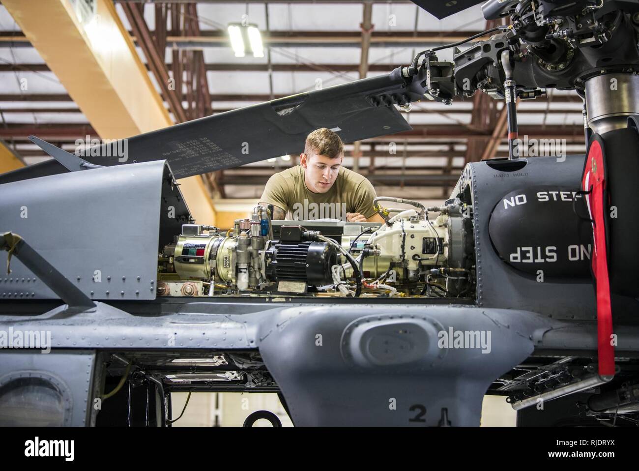 Senior Airman Joshua Herron, 723d Aircraft Maintenance Squadron (AMXS) HH-60G Pave Hawk crew chief, reads a technical order, Jan. 22, 2018, at Moody Air Force Base, Ga. From 16-25 Jan., Airmen from the 723d AMXS performed 216 hours of maintenance on an HH-60 after it returned to Moody following 350 days of depot maintenance at Naval Air Station (NAS) Jacksonville. While at NAS Jacksonville, the HH-60 underwent a complete structural overhaul where it received new internal and external components along with repairs and updated programming. Stock Photo