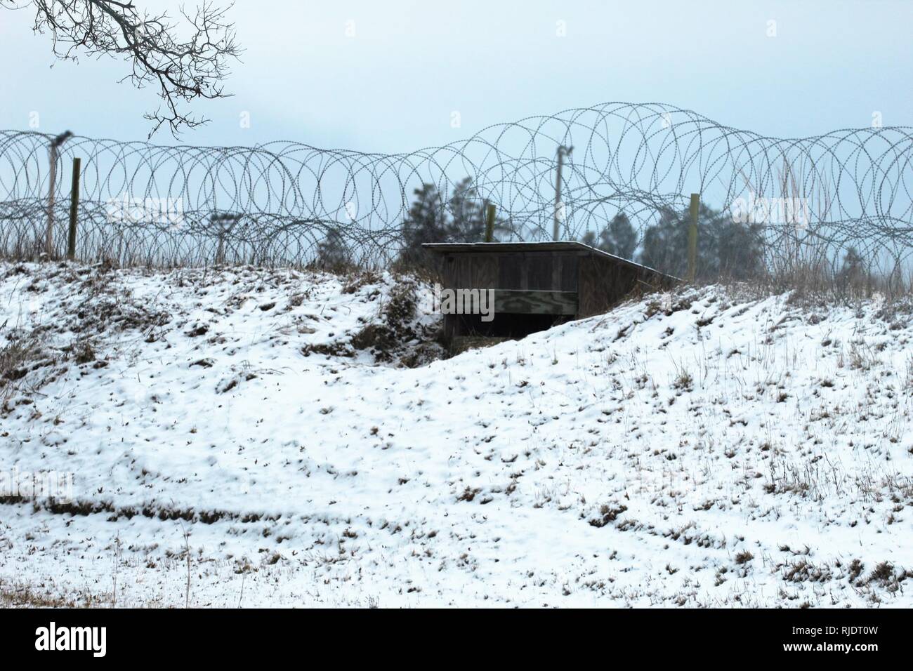 A training area defensive fighting position is shown covered in snow at