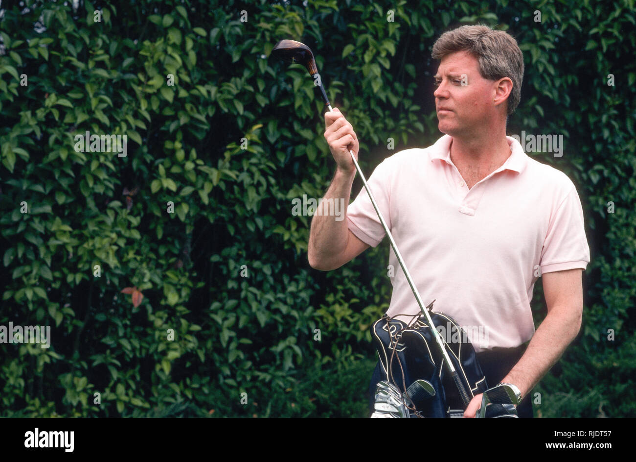 1980s Man preparing to tee off at golf course, USA Stock Photo