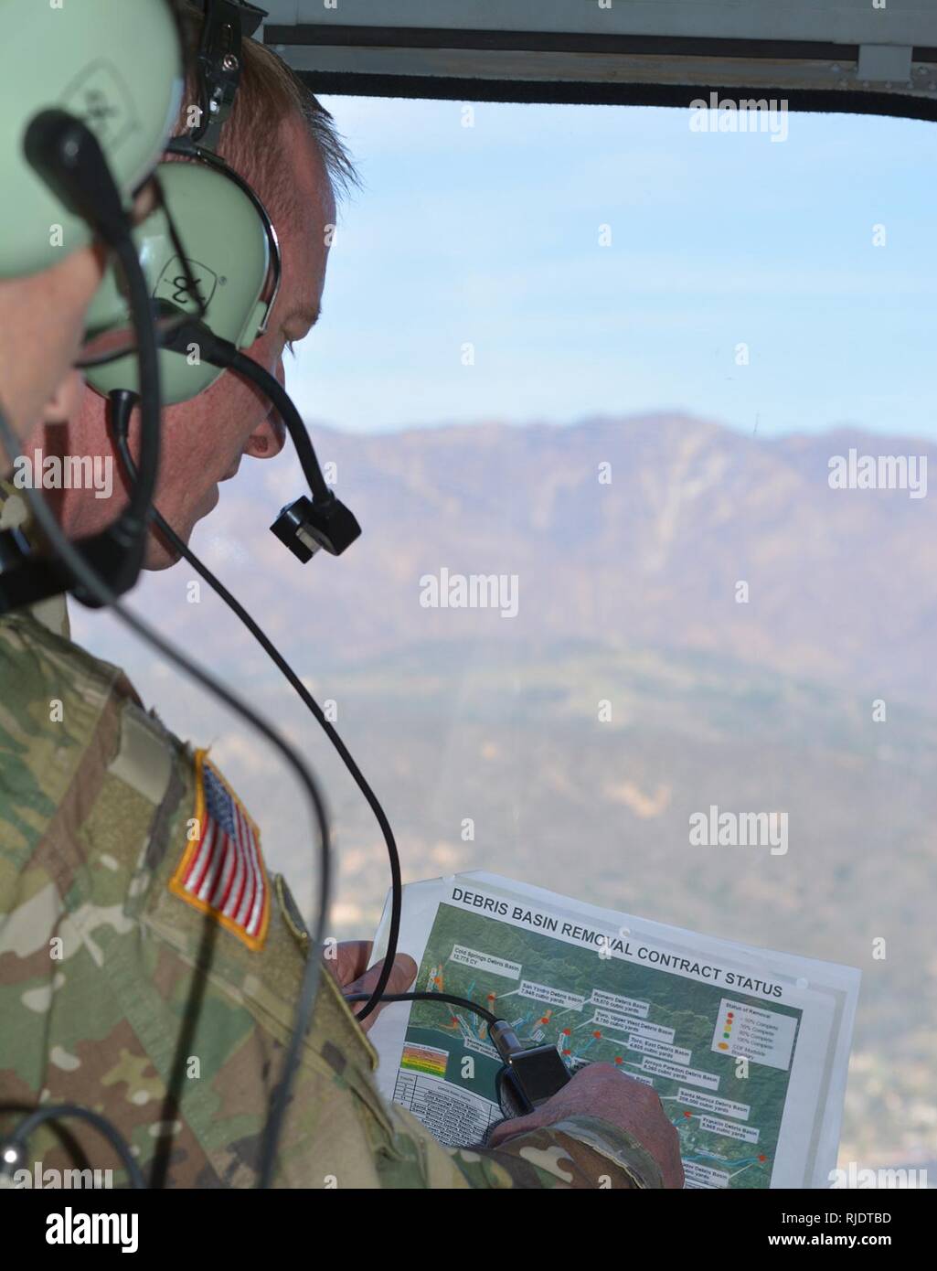 Col. Kirk Gibbs, U.S. Army Corps of Engineers Los Angeles District commander, views a map of the Santa Barbara basins while flying over the area Jan. 18 in a UH-60 Blackhawk helicopter. The Corps completed clearing all 11 basins and 11 channels in Santa Barbara County in April, following a devastating mudslide Jan. 9 in Montecito that took the lives of 23 people. Stock Photo