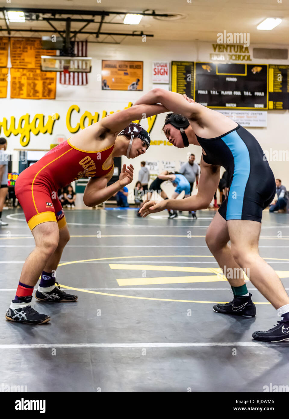 Wrestler from Oxnard High School attempting to gain advantage on feet against Buena athlete during tournament at Ventura High School in California USA Stock Photo