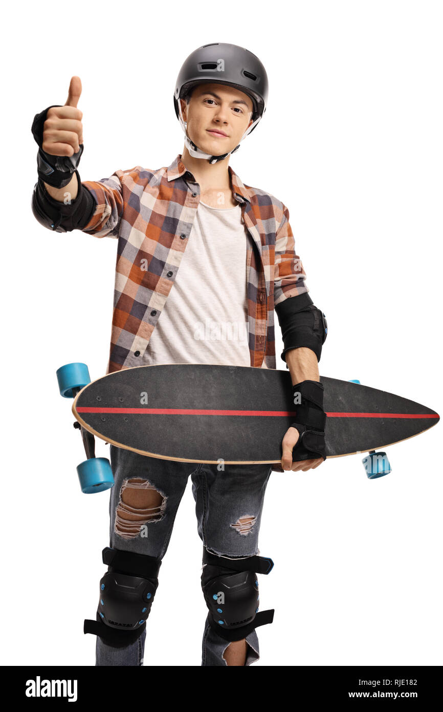 Young boy with a helmet holding a longboard and giving thumbs up isolated on white background Stock Photo