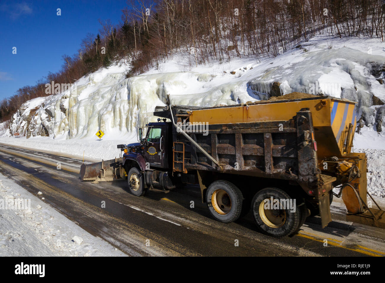 Snow plow truck on Route 112 in Kinsman Notch of Woodstock, New