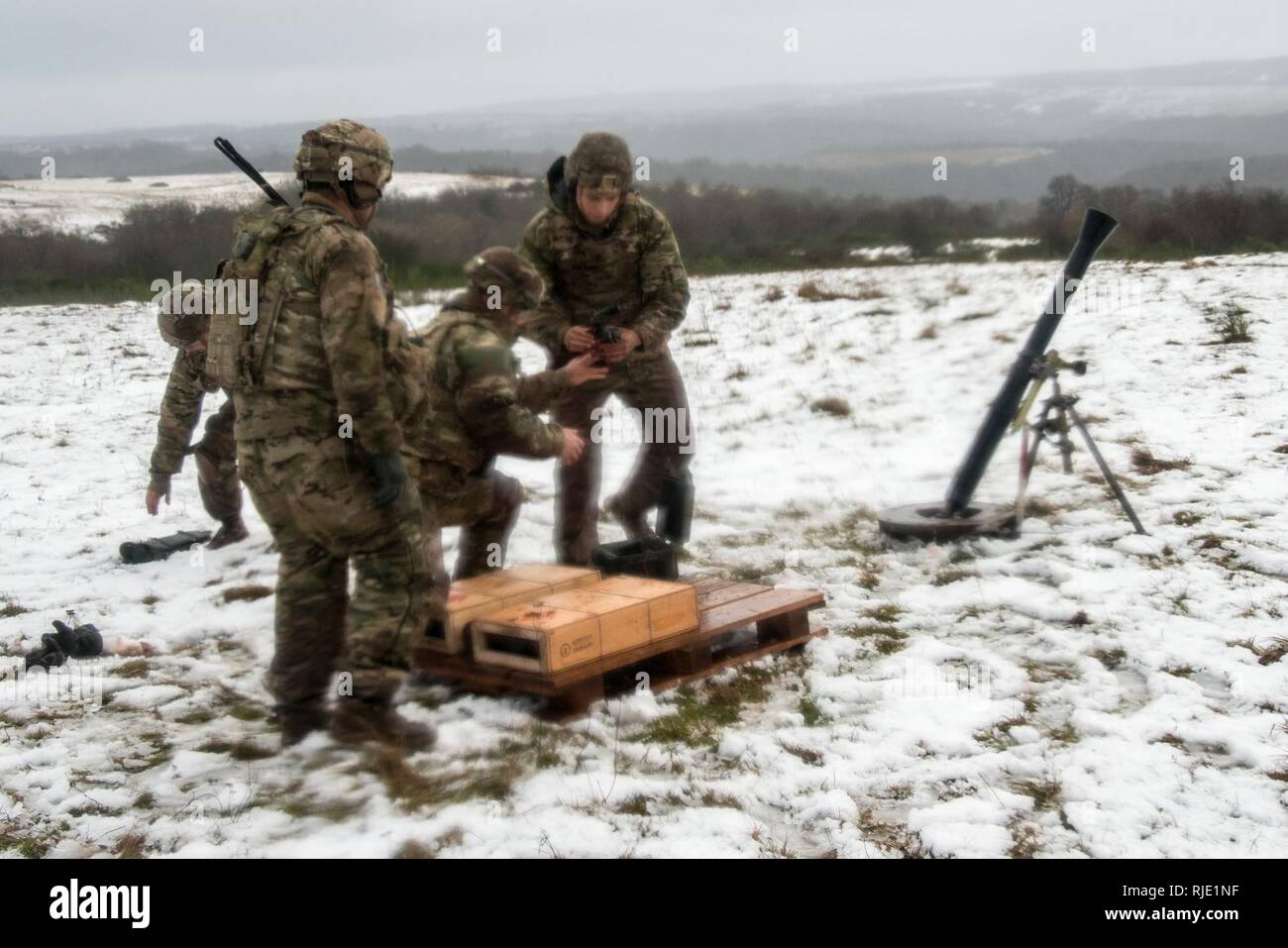 U.S. Soldiers assigned to Headquarters and Headquarters Company, 1st Battalion, 503rd Infantry Regiment, 173rd Infantry Brigade Combat Team (Airborne), fire the M252A1 81mm Mortar System at Mortar Firing Point 1 in the Baumholder Military Training Area, Germany, Jan. 18, 2018. The training provided the Mortarmen the opportunity to increase their proficiency and familiarization with the weapon system. The 173rd Airborne Brigade is the U.S. Army’s Contingency Response Force in Europe, providing rapidly deploying forces to the U.S. Army Europe, Africa and Central Command Areas' of Responsibility  Stock Photo