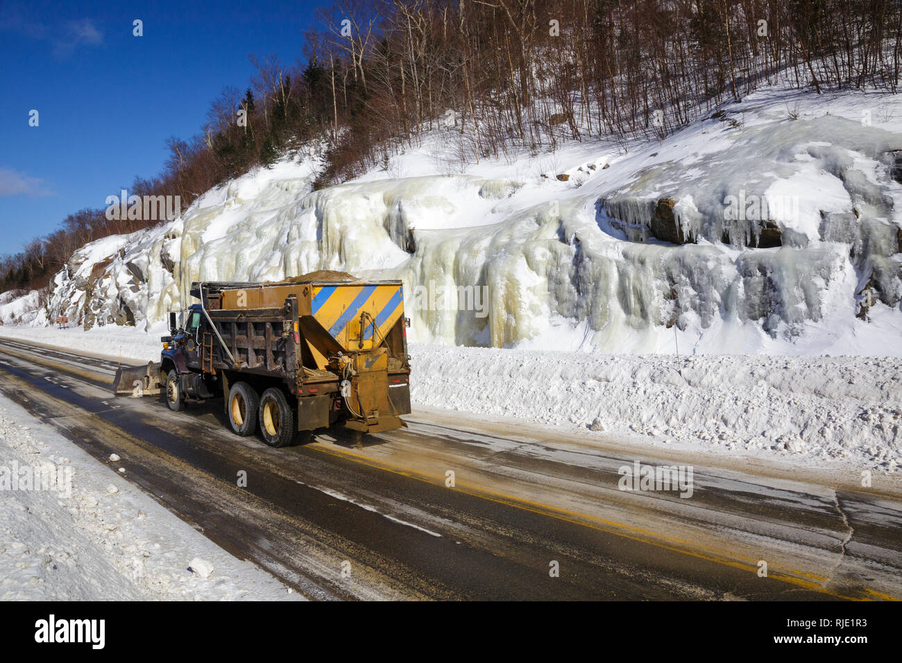 Snow plow truck on Route 112 in Kinsman Notch of Woodstock, New