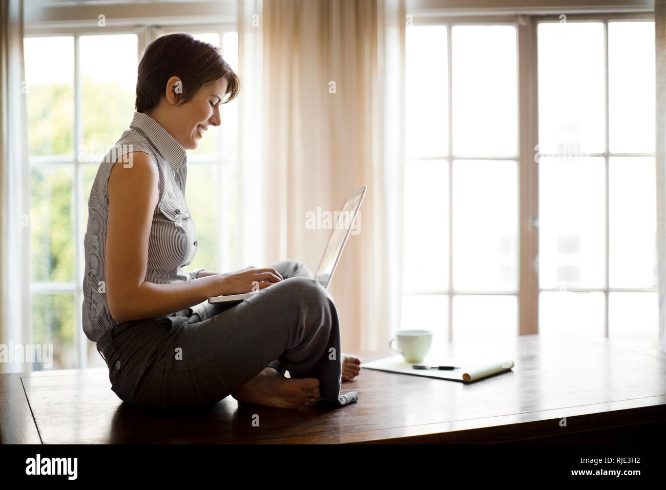 Two happy young women discussing a work project. Stock Photo