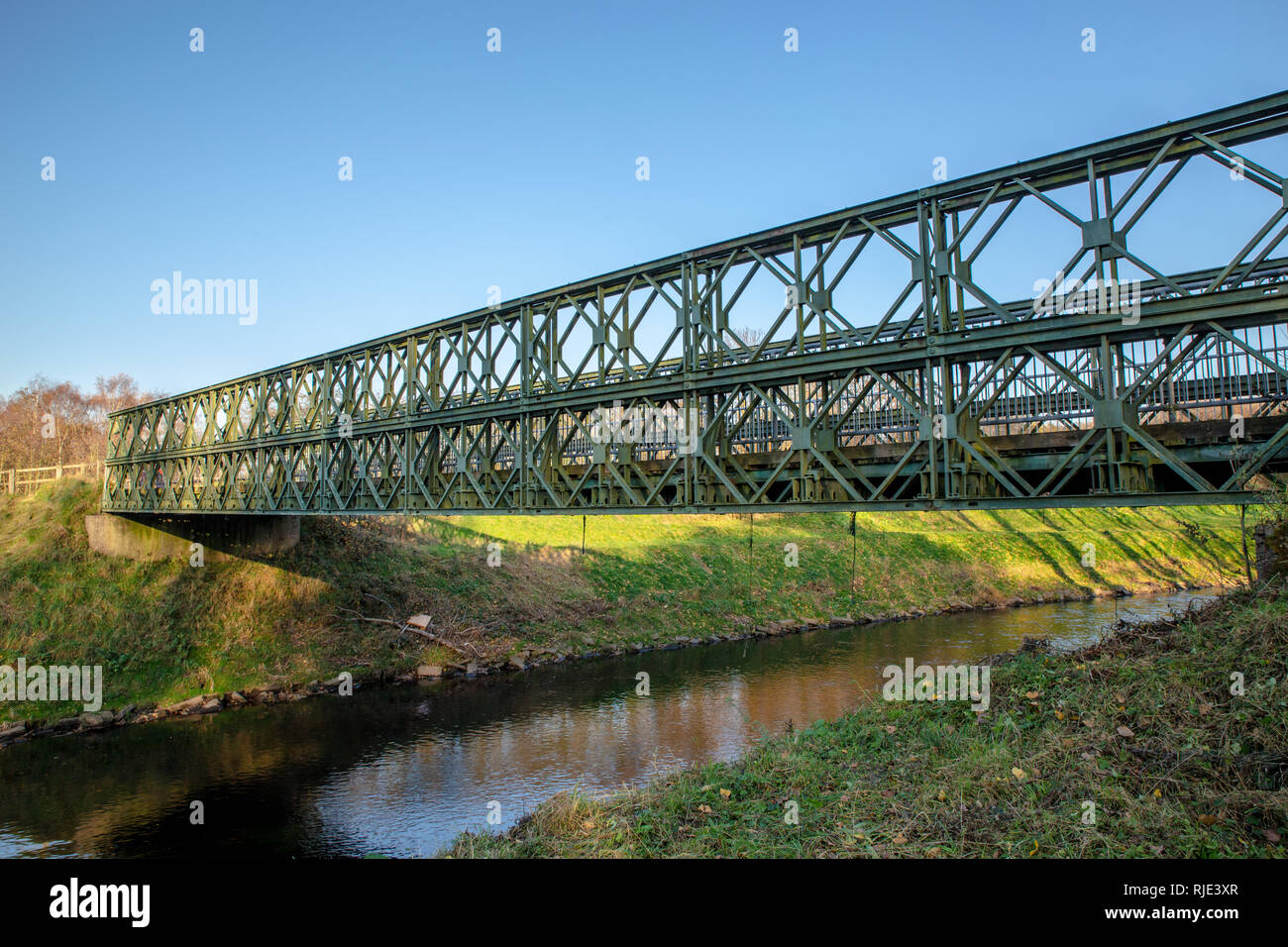 Iron Truss bridge over the River Mersey leading from Sale into Chorlton Water Park Stock Photo