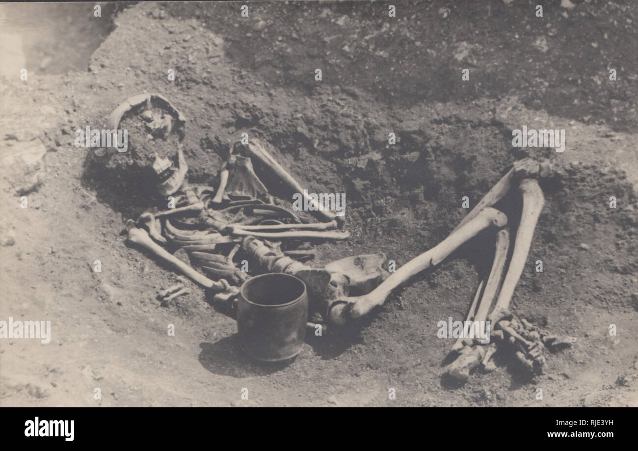 Vintage 1937 Photographic Postcard of a Skeleton Excavated Near The East Gate of Mai Dun, (Maiden Castle) Dorchester, Dorset, England Stock Photo