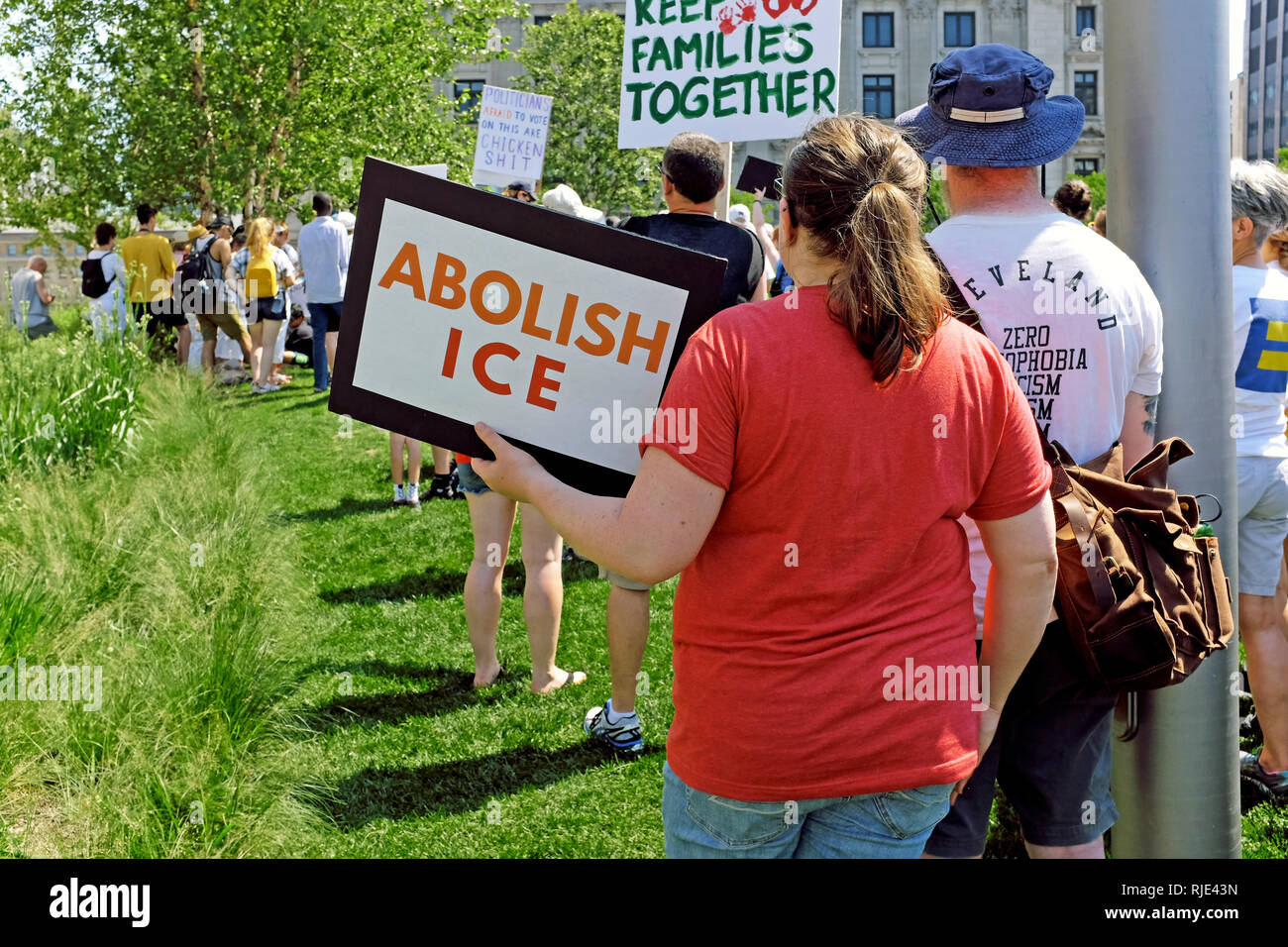 A woman holds an 'Abolish ICE' sign at a June 20, 2018 rally in Cleveland, Ohio, USA demonstrating against Trump immigration policy changes. Stock Photo