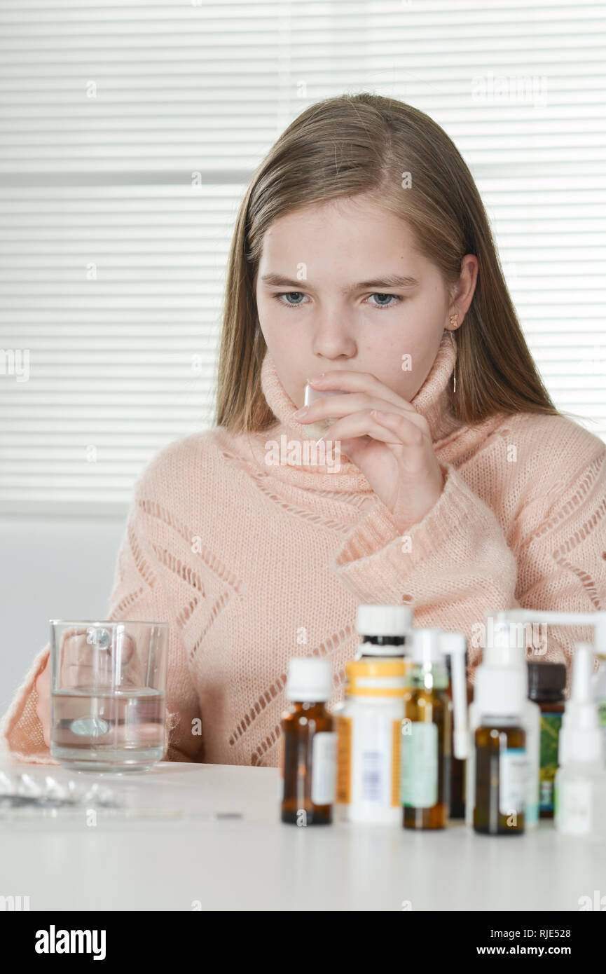 portrait of a sick girl taking medicine at home Stock Photo Alamy