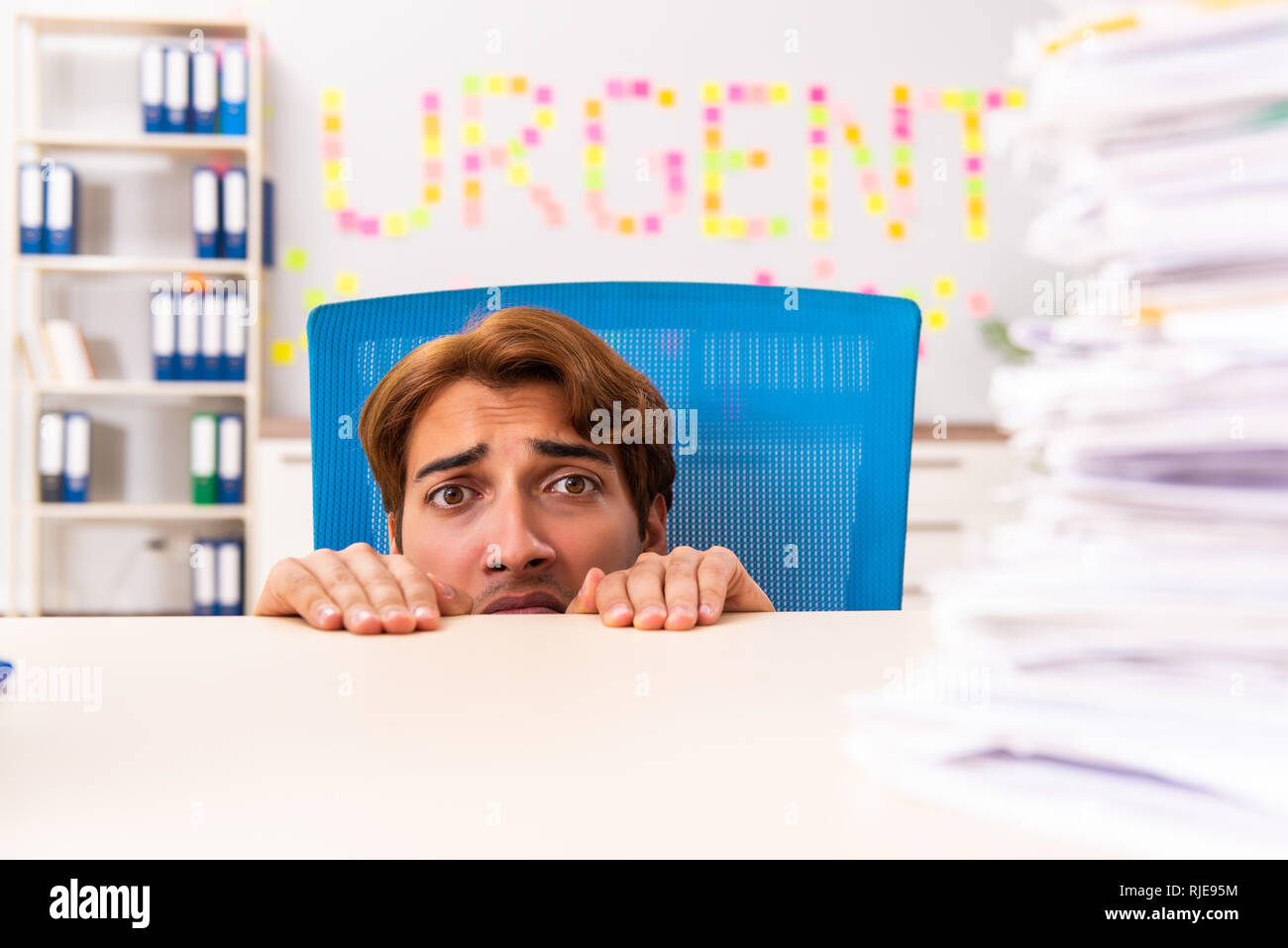 Young employee suffering from excessive work Stock Photo