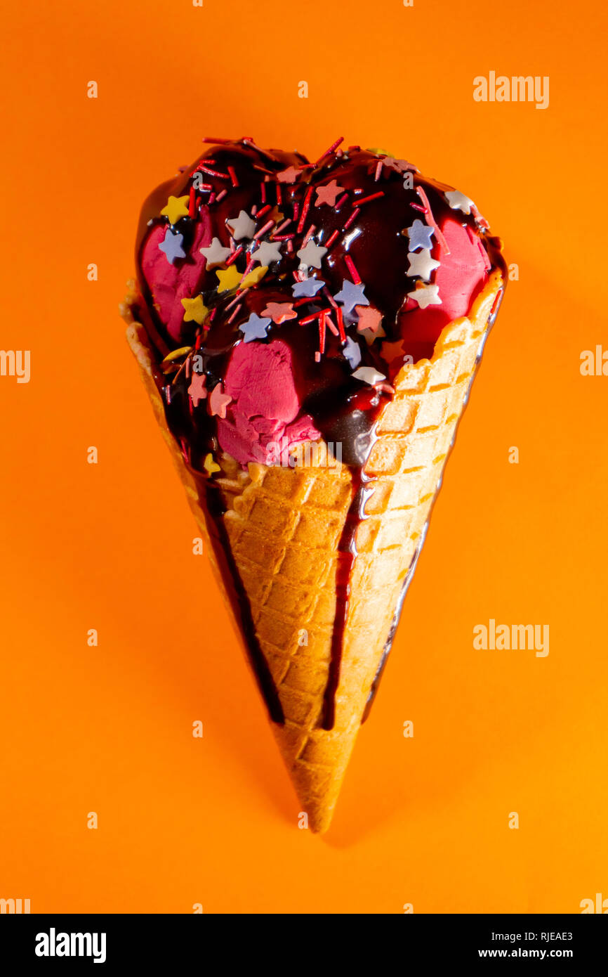 Tasty big cherry ice-cream with chocolate topping Stock Photo