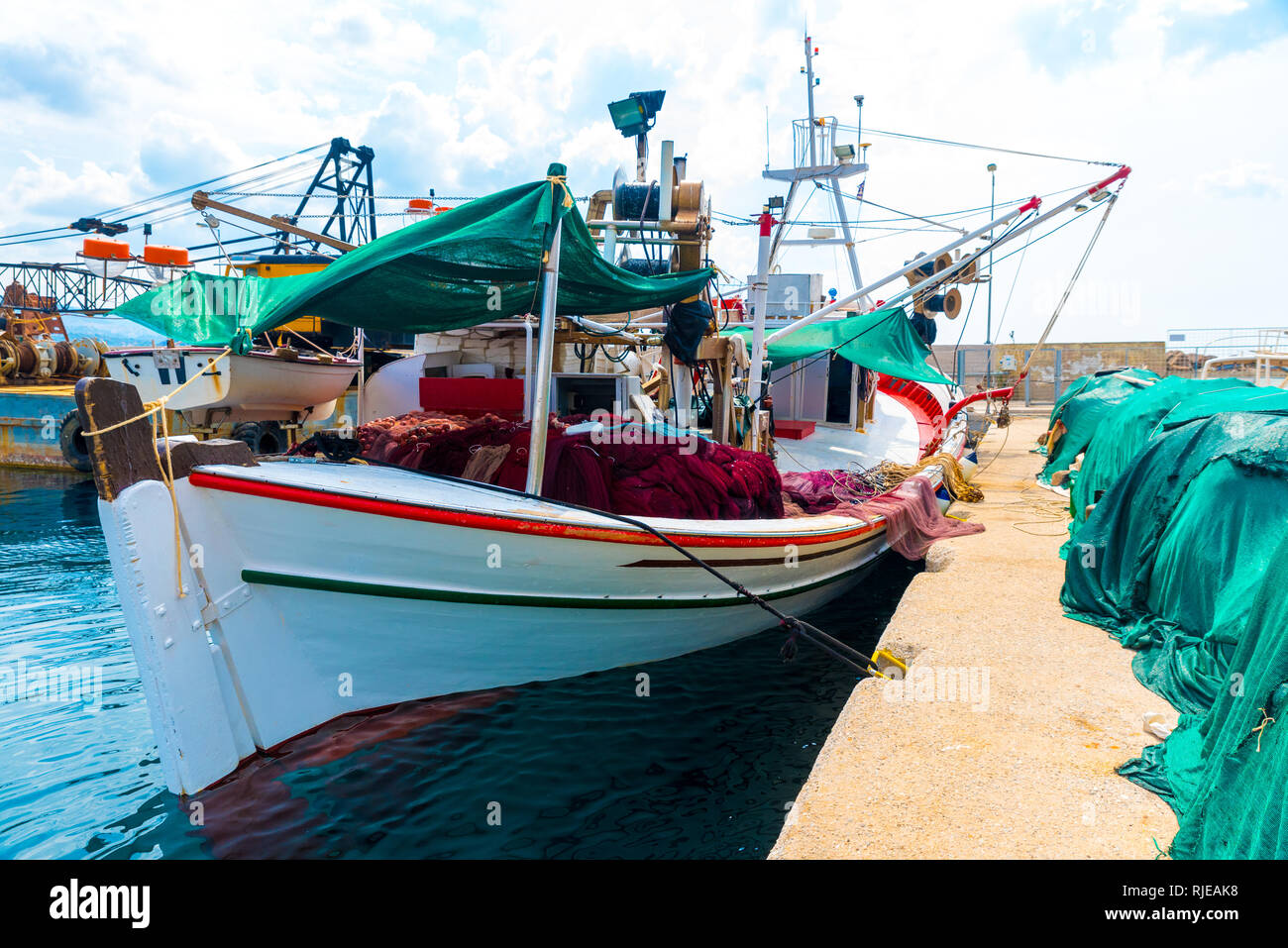 Fishing boat with colorful nets at the dock in Petra, Lesvos