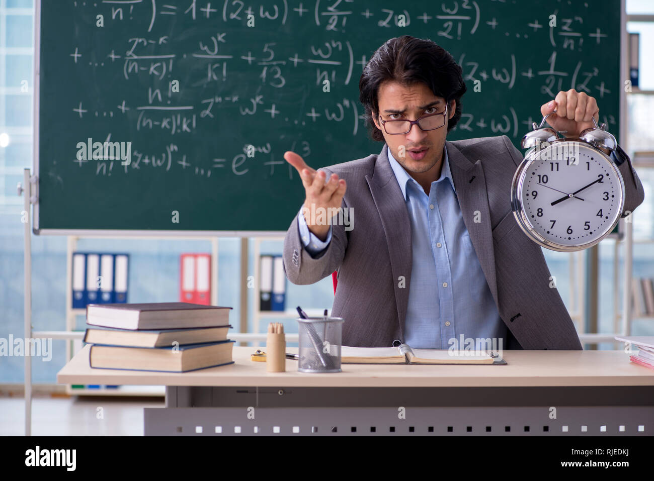 Young handsome math teacher in classroom Stock Photo