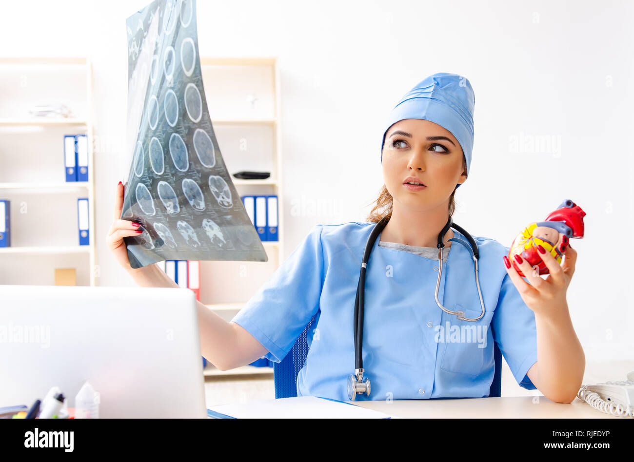 Young female doctor radiologist sitting at the clinic Stock Photo