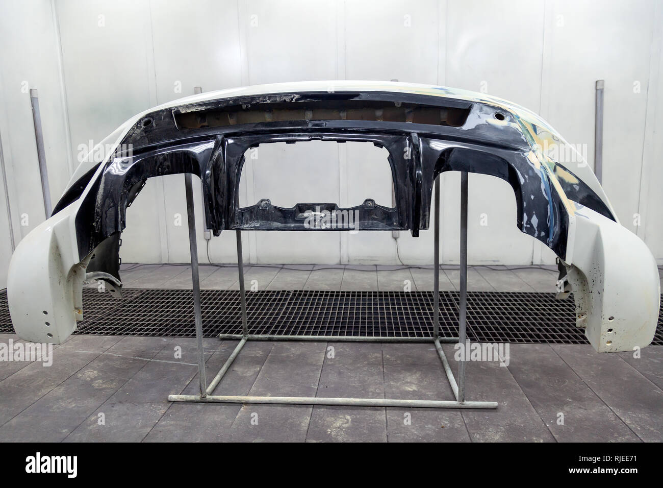 Repair of the rear bumper of a white car after an accident with the